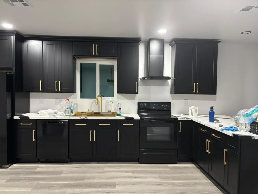 Kitchen remodel with black cabinets and gold hardware
